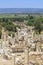 People are walking through ancient streets of Ephesus from memmius monument with library of Celsus background