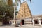 People walking around famouse Hindu temple with carved gopuram gates