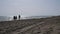 People walking on beach at Marina di Alberese Italy in the sunset