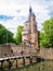 People walking on bridge over moat of Duurstede castle in Wijk b