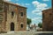 People walking in a cobblestone alley amidst gothic buildings at Caceres