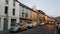 People walking by colorful houses in Kenmare, Kerry, Ireland