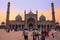 People walking in a courtyard of Jama Masjid at sunset, Delhi, I