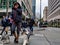 People walking dogs and crossing the street at a busy intersection in downtown Seattle on