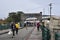 People walking down the Chamberlain Bridge leading to Independence Arch in the old city