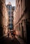 People walking down a traditional Parisian back street with the post-modern pipes and vents of Centre Pompidou in the background