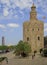 People are walking at golden tower in Seville, Spain