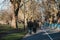 People walking in Haggerston Park in Hackney, East London, UK