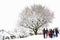 People walking through heavy winter snow. A whiteout scene,