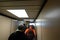 People walking on a jetway to disembark an airplane