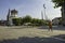 People walking by the Maritime Museum tower along a cobbled path in Dusseldorf, Germany.