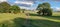 People walking through the meadow towards York Racecourse York city North Yorkshire UK