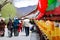 People walking near the golden prayer drums row in the street of Lhasa, Tibet