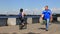 People walking near river, ride bicycles and scooters. Summer, spring recreation, sports in Ukrainian city Dnipro, Dnepropetrovsk