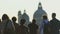 People walking near road, pedestrian crossing, large church on background