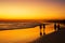 People walking ocean beach sunset