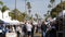 People walking on outdoor street farmers market. Vendors sell locally produced goods, California USA