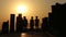 People Walking Over Wooden Bridge at Sunset 1