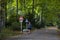 People walking in park of Berlin, water, trees and autumn time, urban recreation