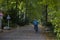 People walking in park of Berlin, water, trees and autumn time, urban recreation