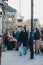 People walking past shops and cafes on Broadway Market, London, UK