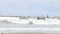 People walking on pier. Waves under the pier in the Black Sea, at Anapa Beach