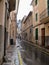 People walking in the rain through the historical town part of S