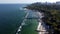 People walking and relaxing on beach on sunny day. Aerial Drone View Flight Over