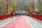 People walking and riding on a rainy foggy day on the downtown Kyiv Pedestrian city bridge right after its reconstruction complet