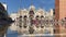 People walking on the San Marco Square of Venice in Italy with reflection on puddle of water.