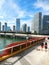 People walking on a sidewalk on along Biscayne Bay