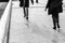 People walking on sidewalk, black and white urban life scene photo