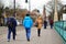 People walking on a sidewalk on the Most Teatralny bridge in Poznan, Poland