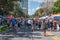 People walking on street with colorful stands at Lake Eola Park area 156.