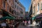 the people walking on the street of a narrow city street