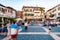 People walking by the streets of the famous Old Town of Sirmione city located on peninsula of Garda lake in Italy. Square full of