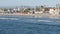 People walking strolling. Pacific ocean, sea water wave. Beachfront vacations resort. California USA