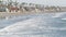 People walking strolling. Pacific ocean, sea water wave. Beachfront vacations resort. California USA