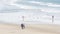 People walking strolling. Pacific ocean, sea water wave. Beachfront vacations resort. California USA