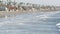 People walking strolling. Pacific ocean, sea water wave. Beachfront vacations resort. California USA