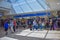 People walking to different terminals and top view of tickets and check-in blue sign at Orlando International Airport 1