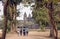 People walking to historical walls of Angkor What temple, Cambodia. 12th century landmark in Khmer style architecture