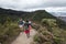 People walking into a trekking path at easter mountains with bogota landscape