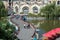 People walking on twisty bridge in the amusement park.