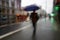 People walking with an umbrella in rainy days in Bilbao city Spain