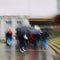 People walking with an umbrella in rainy days in Bilbao city Spain