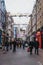 People walking under Bohemian Rhapsody themed Christmas lights in Carnaby Street, London, UK