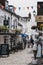 People walking under the colourful bunting on a street in Lymington, New Forest, UK