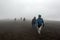 People walking up Cotopaxi which is an active strato volcano in Ecuador.