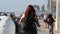 People walking, waterfront promenade beachfront boardwalk. Ocean beach near Los Angeles, California USA